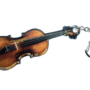 May include: A brown violin keychain with a silver chain and a silver ring. The violin has a printed image of a violin and the word "aimgifts" is printed on the bottom.