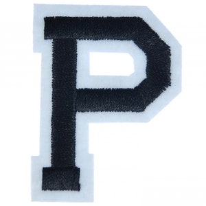May include: Black felt letter P with white outline. The letter is a capital letter and is approximately 3 inches tall.