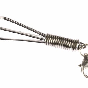 Könnte beinhalten: Ein silberner Schneebesen-Schlüsselanhänger mit einem federnden Metallverbinder und einem silbernen Verschluss.