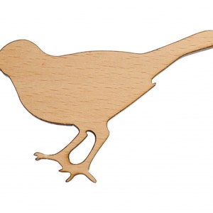 May include: A wooden cutout of a bird in a light brown color. The bird is facing right and has its wings spread out.