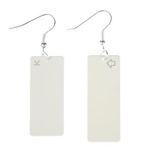 May include: A pair of off-white rectangular earrings with silver hooks. The left earring has a small 'V' symbol and the right earring has a small left arrow symbol.