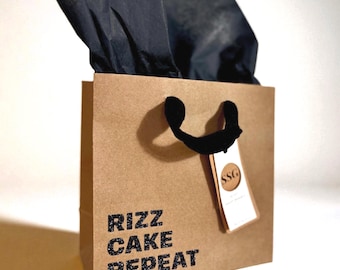Funny Gift Bag | "Rizz, Cake, Repeat" | Reusable Kraft Gift Glitter Bag with Tissue Included | Eco Friendly