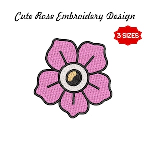 May include: A pink flower embroidery design with black outlines and a yellow and black center. The design is labeled "Cute Rose Embroidery Design" and includes a red tag that says "3 SIZES".