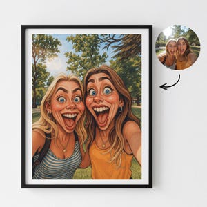 May include: A framed cartoon print featuring two women with exaggerated facial expressions, smiling widely. One woman wears a striped top, the other a yellow top. A smaller, circular photo of the women is in the upper right corner.