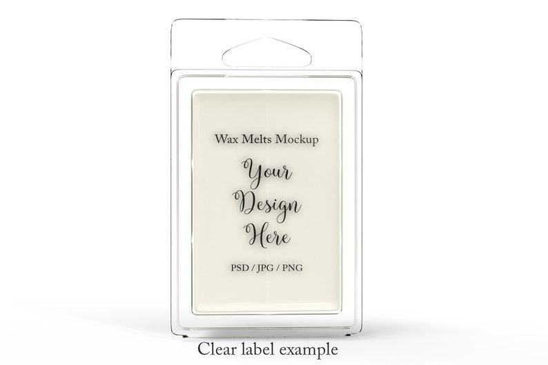 May include: Clear plastic packaging containing a rectangular wax melt. The label reads "Wax Melts Mockup" with the text "Your Design Here" in a script font. The bottom of the label says "PSD / JPG / PNG". The words "Clear label example" are at the bottom.