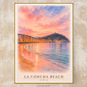 May include: A watercolor print of La Concha Beach in Spain featuring a coastal city skyline, a sandy beach, and calm ocean waters under a vibrant pink and blue sunset sky. The text LA CONCHA BEACH SPAIN is printed at the bottom of the artwork.