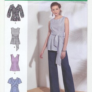 May include: A sewing pattern for a women's top with four different styles. The pattern is from Simplicity and is numbered S8921 D5. The top is shown in a variety of colors and patterns, including floral, plaid, and solid.