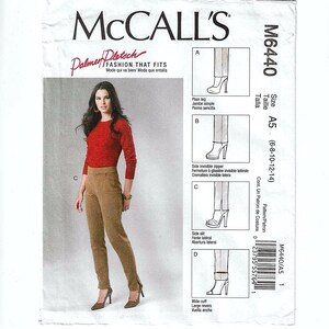 May include: McCall's sewing pattern M6440. The pattern features a woman wearing a red long-sleeve top and brown pants. The pattern includes illustrations of different pant styles, including plain leg, side zipper, side slit, and wide cuff.