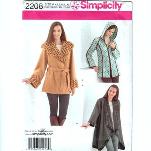 May include: Simplicity sewing pattern 2208 featuring three different coat designs. The pattern includes sizes XS to XL. The image shows a tan coat with a textured collar and cuffs, a hooded coat with polka dots, and a gray coat with decorative trim.