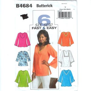May include: A Butterick sewing pattern, B4684, featuring six tunic designs. The pattern includes a variety of styles with long sleeves and decorative trim. The cover shows a woman wearing an orange tunic with gold trim.