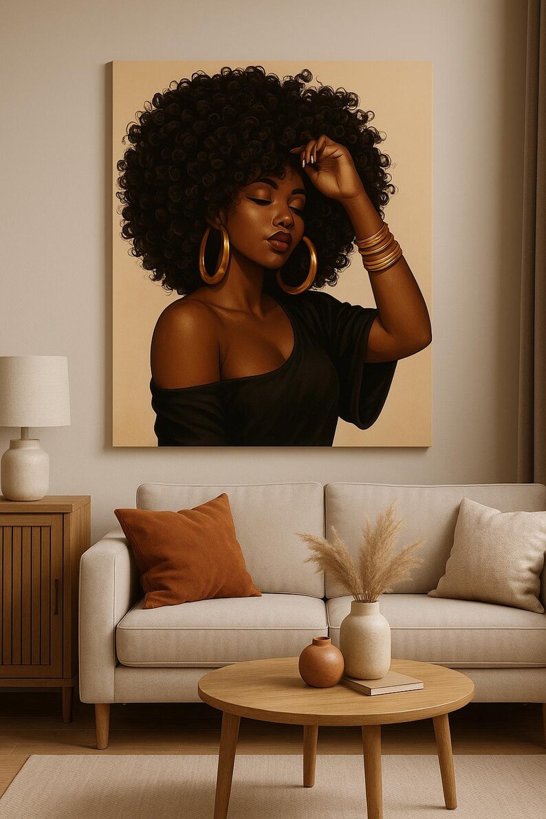 May include: A canvas print of a woman with dark skin and curly black hair. She wears a black off-the-shoulder top and large gold hoop earrings. Her arm is raised, adorned with gold bracelets. The artwork hangs above a beige sofa with orange and beige pillows.