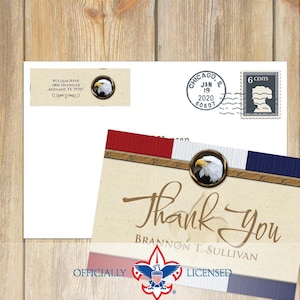 May include: A stationery set featuring a thank you card, envelope, and address label. The card and label have an eagle emblem. The card reads "Thank You" and "Brannon T. Sullivan". The envelope has a stamp and a postmark from Chicago, Illinois.