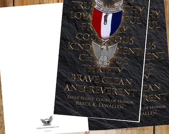 May include: A black and gold Eagle Scout Court of Honor card with a red, white, and blue medal. The card features the Scout Law and the text "Be Prepared". The card is officially licensed.