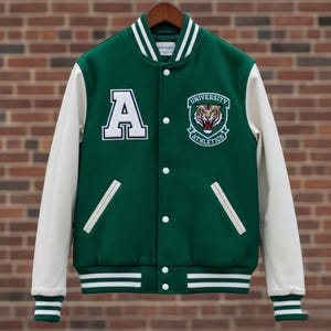 May include: Green varsity jacket with cream sleeves, displaying a large white "A" patch and a "UNIVERSITY ATHLETICS" emblem with a tiger. The jacket has white stripes on the collar, cuffs, and hem, and white pocket trim.