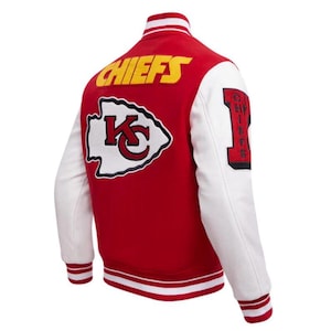 May include: Red and white varsity jacket with the word "CHIEFS" in yellow lettering on the back. The jacket features white sleeves and a "KC" logo patch. The number "1" is on the right sleeve.