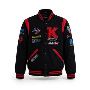 May include: A black varsity jacket with red leather sleeves and striped red and black ribbed cuffs and collar. The front features multiple embroidered patches including a large red letter K, the text Kavinsky, Zombie, and Renegade.