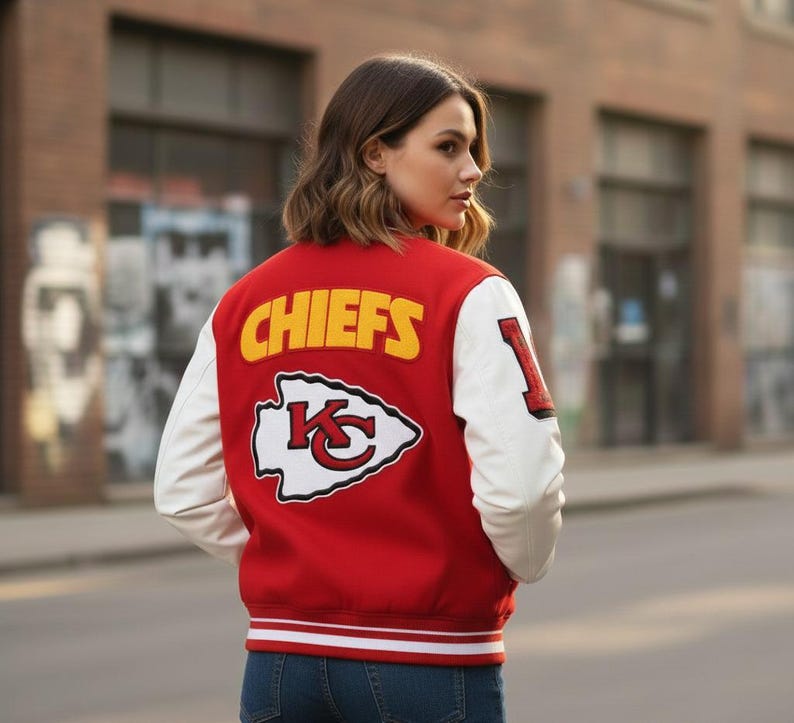 May include: A red and white letterman jacket with the word "CHIEFS" in yellow block letters across the back. The jacket features white sleeves and a team logo patch. The number "1" is on the left sleeve.