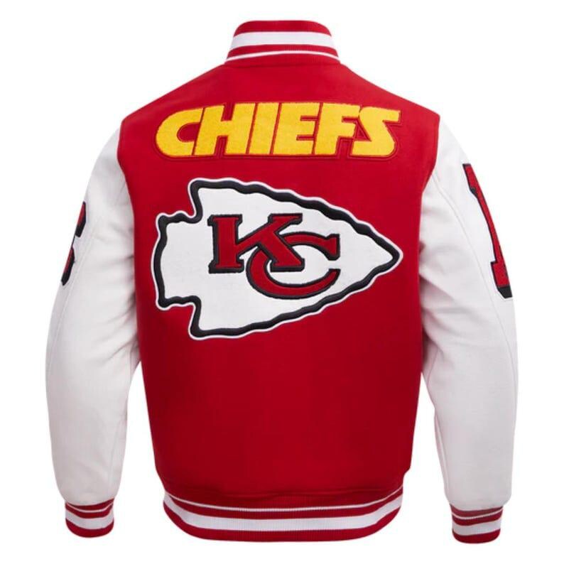 May include: Red and white varsity jacket with the word "CHIEFS" in yellow block letters across the back. A white arrowhead logo with a red "KC" is centered below the text. The sleeves are white, and the jacket has a striped collar and cuffs.