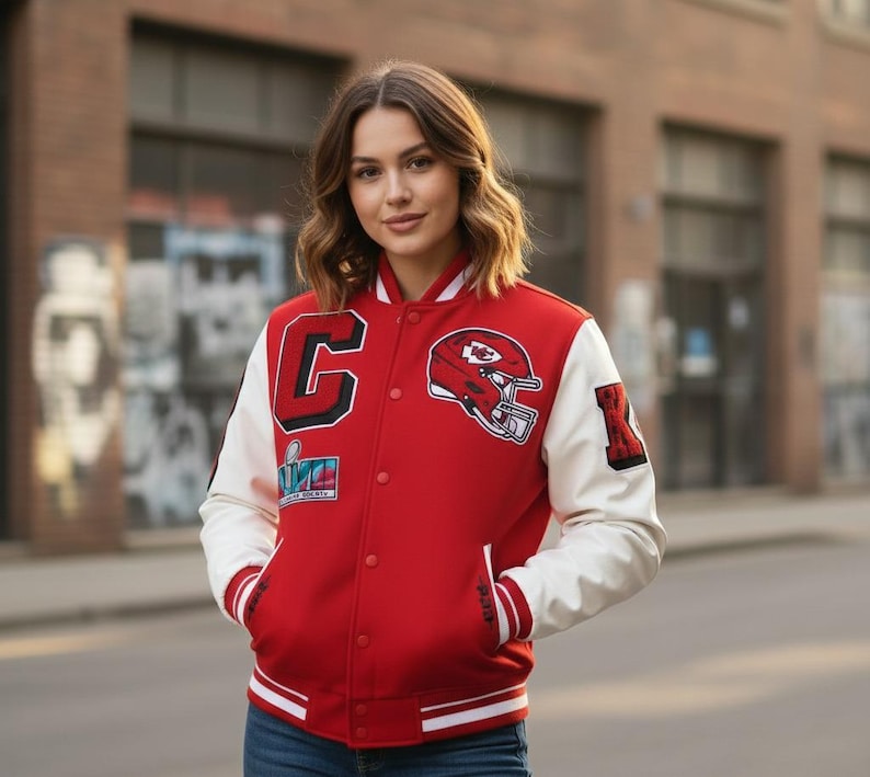 May include: Red and white varsity jacket with a snap-button closure. The jacket features a large "C" patch, a football helmet graphic, and a "Super Bowl" patch. The sleeves are white, and the jacket has red and white striped cuffs and hem.