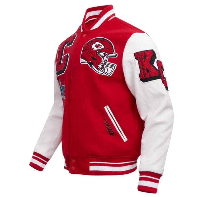 May include: Red and white varsity jacket with a football helmet patch and the letter "K". The jacket has white sleeves, a red body, and white stripes on the cuffs and hem. The jacket has a button-up front.