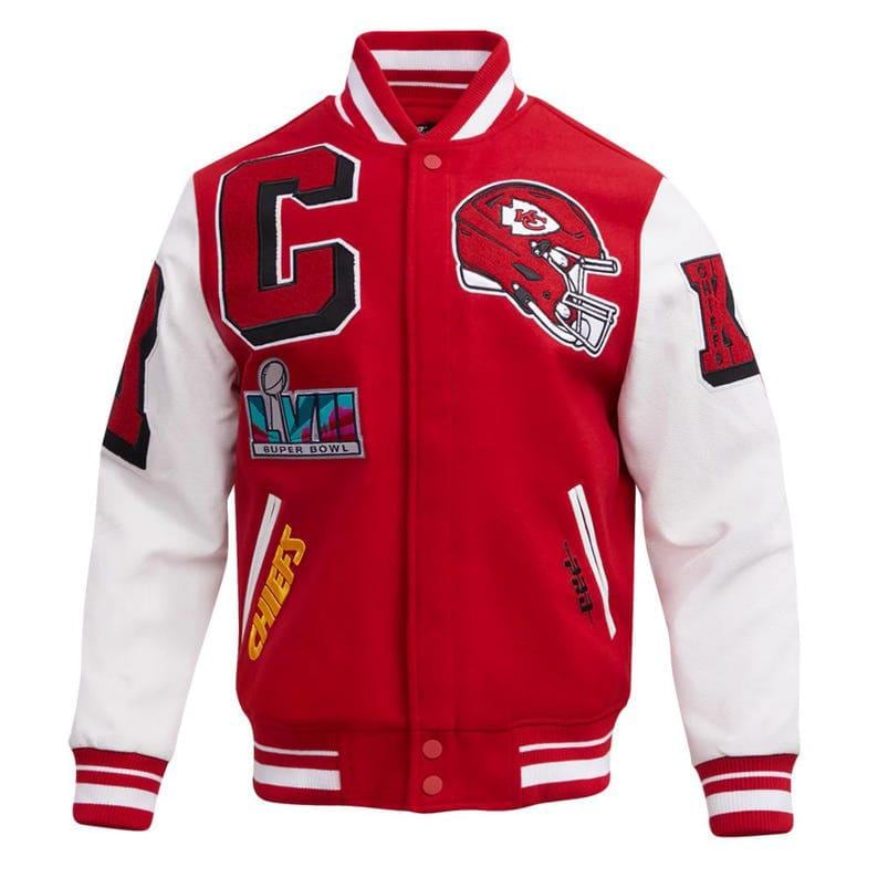 May include: Red and white varsity jacket with the Kansas City Chiefs logo and Super Bowl LVII patch. The jacket features a large "C" and the word "Chiefs" in yellow. The sleeves are white, and the jacket has a button-up front.