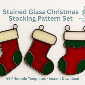 May include: Three stained glass Christmas stocking patterns. Each stocking is red with a green heel and toe, and a cream-colored cuff. The stockings are outlined in a dark metal and have a loop at the top for hanging. The text reads "Stained Glass Christmas Stocking Pattern Set."