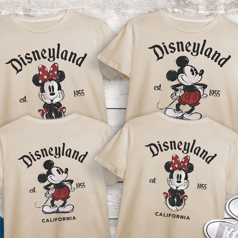 May include: Four cream-colored t-shirts featuring Disneyland graphics. Each shirt has a different Mickey or Minnie Mouse design, with the text "Disneyland" and "est. 1955". Two shirts also say "California".