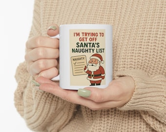 May include: White ceramic mug featuring the text "I'M TRYING TO GET OFF SANTA'S NAUGHTY LIST" with an illustration of Santa Claus holding a list marked "NAUGHTY". The mug has a standard handle and a glossy finish.
