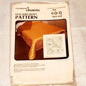 May include: A full-size quilt pattern by Jeaneau, packaged in a clear plastic sleeve. The package features a photo of a gold quilt and an illustration. The pattern is size 40-Q, 90 x 108 inches.