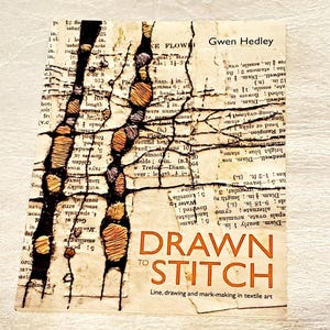 May include: A book cover titled "Drawn to Stitch" by Gwen Hedley. The cover features a collage of vintage book pages with stitched designs in orange and brown thread. The title is in large orange letters.