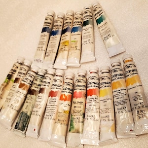 May include: A collection of 18 tubes of Cotman Water Colours, each tube is 8 ml (0.27 fl oz) and labeled with the color name and number. The colors include Alizarin Crimson, Cadmium Yellow, Cadmium Red Hue, and Rose Madder.