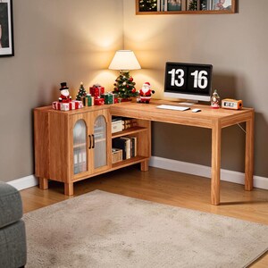 May include: A wooden corner desk with a cabinet and shelves. The desk has a computer monitor displaying "13 16". Christmas decorations, including a tree and Santa figurines, adorn the desk and cabinet.