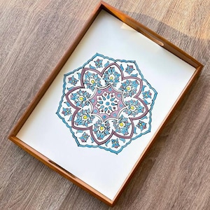 May include: A rectangular wooden serving tray with a white interior featuring a detailed floral design in shades of blue, purple, and yellow. The tray has a brown wooden frame and integrated handles, suitable for serving food or displaying decorative items.