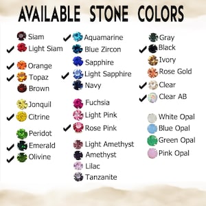 May include: A color chart titled AVAILABLE STONE COLORS displaying rows of small circular gemstones in various hues including Siam, Light Siam, Orange, Topaz, Brown, Jonquil, Citrine, Peridot, Emerald, Olivine, Aquamarine, Blue Zircon, Sapphire, Light Sapphire, Navy, Fuchsia, Light Pink, Rose Pink, Light Amethyst, Amethyst, Lilac, Tanzanite, Gray, Black, Ivory, Rose Gold, Clear, Clear AB, White Opal, Blue Opal, Green Opal, and Pink Opal.