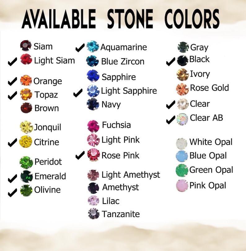 May include: A color chart titled AVAILABLE STONE COLORS displaying rows of small circular gemstones in various hues including Siam, Light Siam, Orange, Topaz, Brown, Jonquil, Citrine, Peridot, Emerald, Olivine, Aquamarine, Blue Zircon, Sapphire, Light Sapphire, Navy, Fuchsia, Light Pink, Rose Pink, Light Amethyst, Amethyst, Lilac, Tanzanite, Gray, Black, Ivory, Rose Gold, Clear, Clear AB, White Opal, Blue Opal, Green Opal, and Pink Opal.