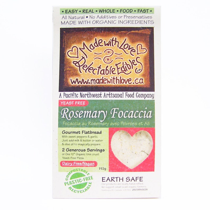 May include: A green and brown package for Rosemary Focaccia, a yeast-free gourmet flatbread. The package features a heart-shaped image of the focaccia and the text "Made with Love" and "Delectable Edibles". The package is 192g and is compostable, plastic-free, and recyclable.