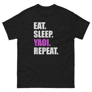 May include: Black t-shirt with the text "EAT. SLEEP. YAOI. REPEAT." in white and purple lettering. The shirt has a crew neck and short sleeves.