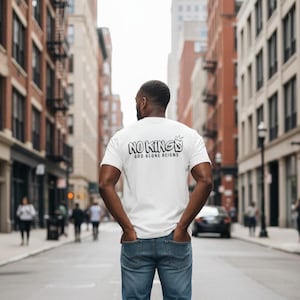 May include: A white ceramic mug with a black handle and the text "But First, Coffee" in a bold, black font. The mug is set against a blurred background, suggesting a cozy setting.
