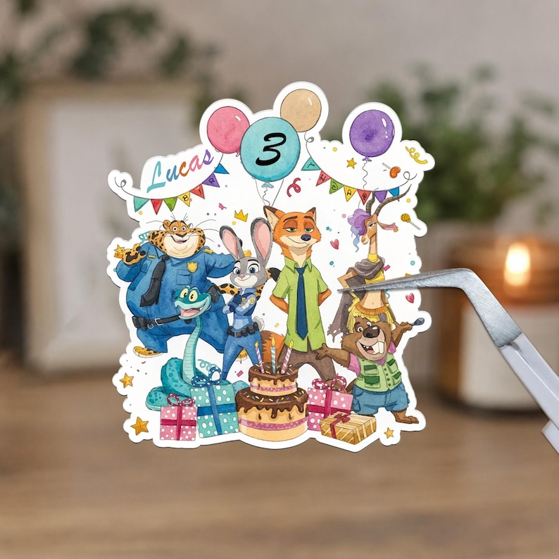 May include: A die-cut sticker featuring Zootopia characters including a cheetah, rabbit, fox, gazelle, and beaver around a birthday cake. The design includes balloons, colourful gift boxes, bunting, and the text Lucas and the number 3.