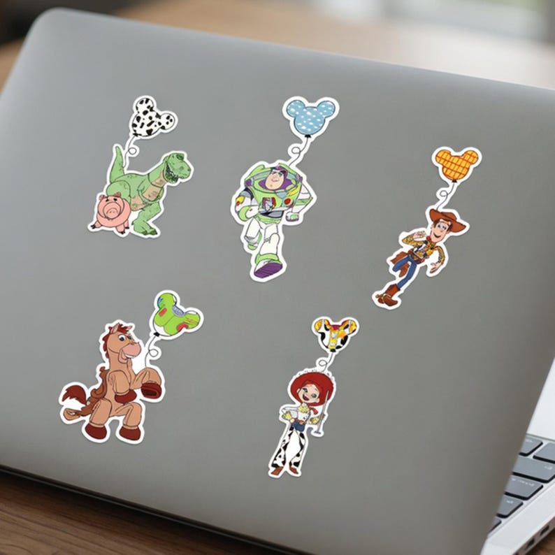 May include: A collection of colorful stickers featuring characters from the Toy Story movie franchise. The stickers include Rex the dinosaur, Buzz Lightyear, Woody, Jessie, and Bullseye, each holding a balloon.
