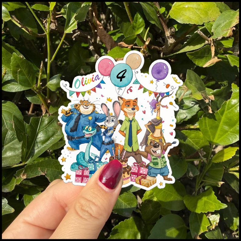 May include: A die-cut sticker featuring Zootopia characters including Judy Hopps, Nick Wilde, Chief Bogo, and Flash. The design includes colourful balloons, gift boxes, a birthday cake, and the text Olivia 4, set against a white background.