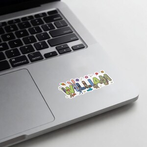 May include: A rectangular sticker featuring the name WILLIAM in large, colorful, block-style letters. Each letter incorporates cartoon animal characters, including a fox, rabbit, and squirrel, with small decorative icons like stars and flowers.