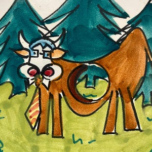 May include: A hand-painted ceramic plate with a cartoon cow wearing glasses and a tie, set against a backdrop of green trees and a green field. The cow is brown with a distinctive design. The plate has a white border.
