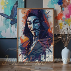 May include: Framed art print featuring a stylized illustration of the Guy Fawkes mask, a symbol of protest. The artwork showcases a portrait with a white mask, a black hooded cloak, and colorful paint splatter effects. The print is in a wooden frame.