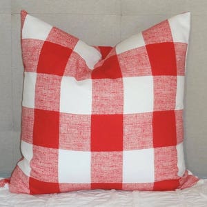 May include: Red and white checked throw pillow with a soft, textured fabric.