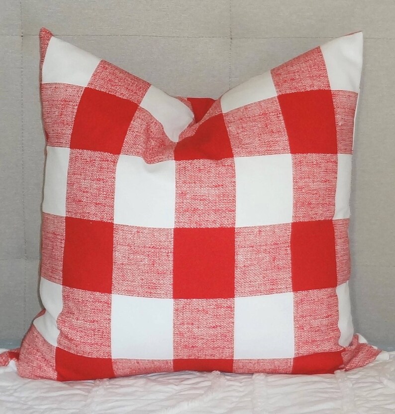May include: Red and white checked throw pillow with a soft, textured fabric.