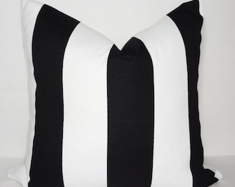 May include: Black and white striped throw pillow with a square shape.