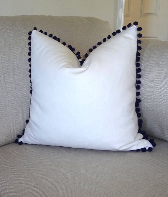 navy pom pom pillow