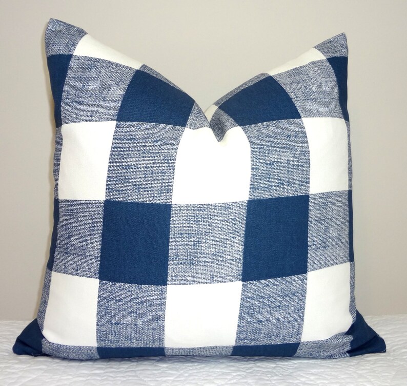 May include: A blue and white checked throw pillow with a woven texture.