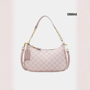 May include: A pale pink shoulder bag featuring a repeating geometric design. The bag has a curved silhouette, a gold chain strap, and a matching pink handle. A small tag hangs from the side. The text "EBUBAG" is in the upper right corner.